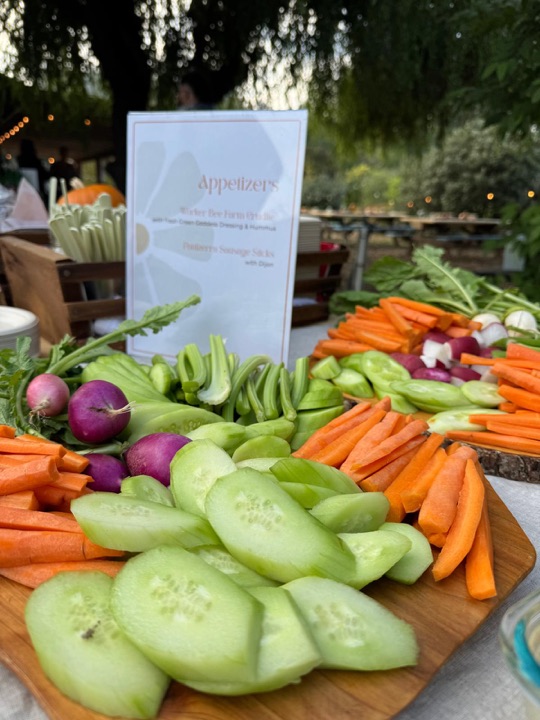 The appetizer table: carrots, cucumbers and radishes from the farm, with a menu card.